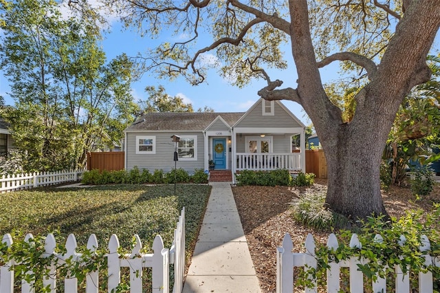 bungalow with covered porch and fence private yard