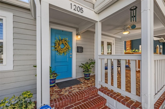 property entrance with a porch and a ceiling fan