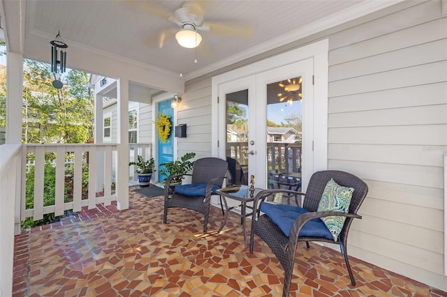 sunroom / solarium featuring french doors and ceiling fan