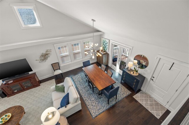 1205 13th St N, Saint Petersburg, FL 33705 - living room with lofted ceiling, wood finished floors, and baseboards