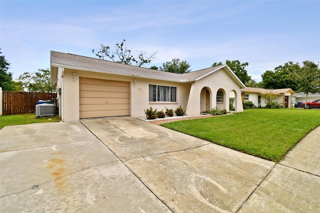 single story home featuring stucco siding, a front lawn, fence, cooling unit, and concrete driveway