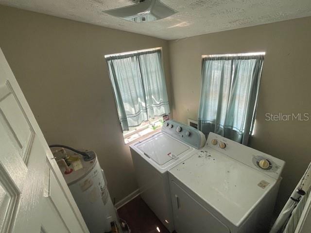 laundry area with a ceiling fan, plenty of natural light, separate washer and dryer, and laundry area