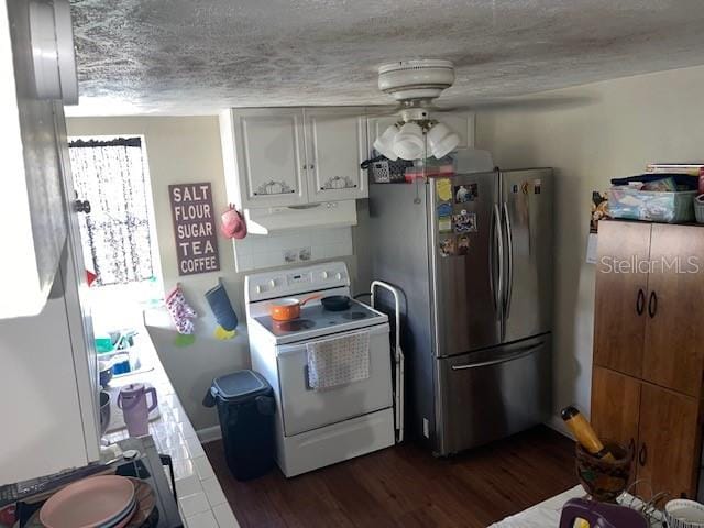 kitchen with white range with electric cooktop, under cabinet range hood, a textured ceiling, dark wood-style floors, and freestanding refrigerator