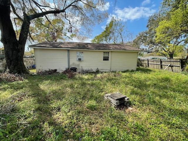 back of property featuring fence