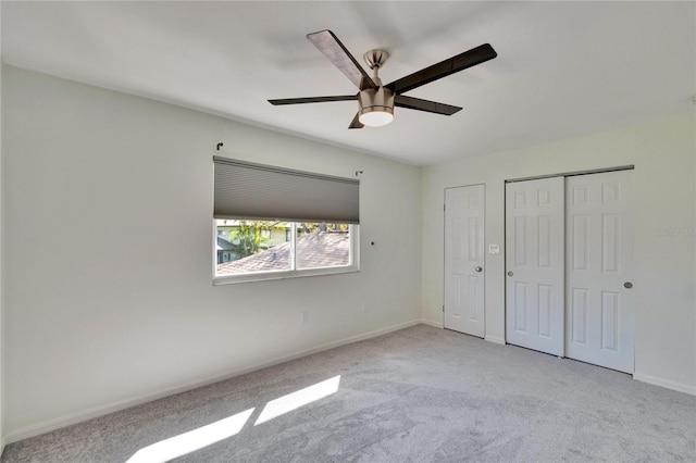 unfurnished bedroom featuring a closet, ceiling fan, baseboards, and carpet floors