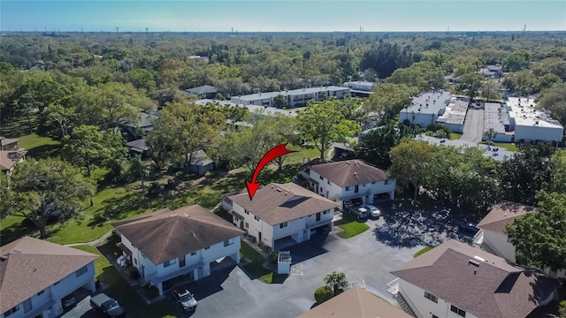 birds eye view of property featuring a wooded view and a residential view