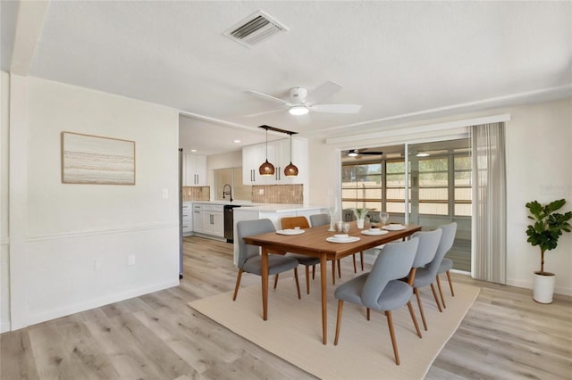 dining space with visible vents, baseboards, and light wood-style floors