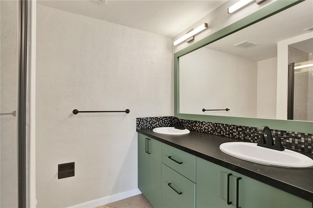 full bath featuring tasteful backsplash, visible vents, tile patterned flooring, and a sink