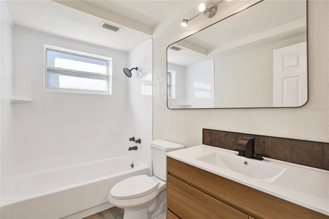 full bathroom with tub / shower combination, visible vents, toilet, and vanity