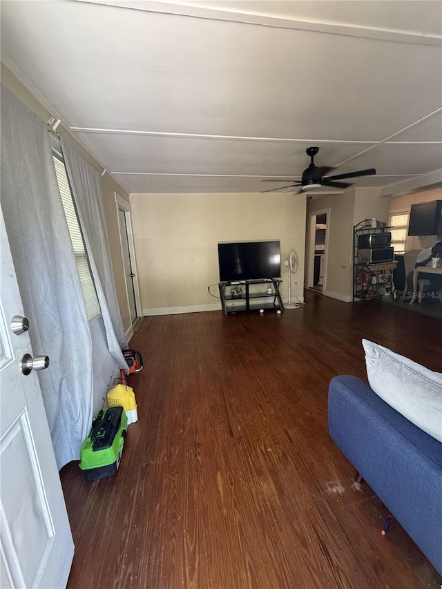 living area featuring a ceiling fan, wood finished floors, and baseboards