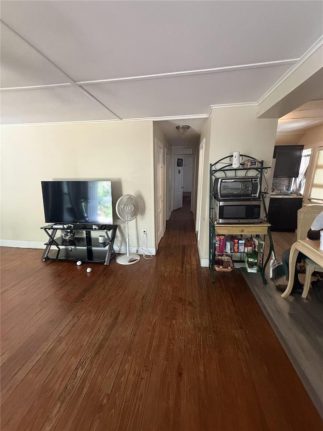 hallway featuring wood finished floors and baseboards