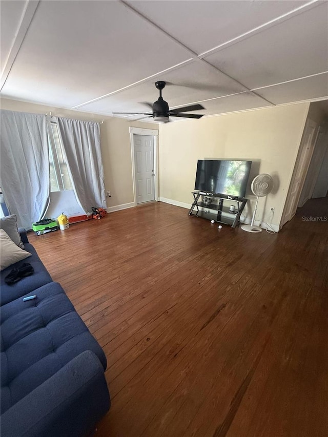 living room with baseboards, a ceiling fan, and hardwood / wood-style flooring