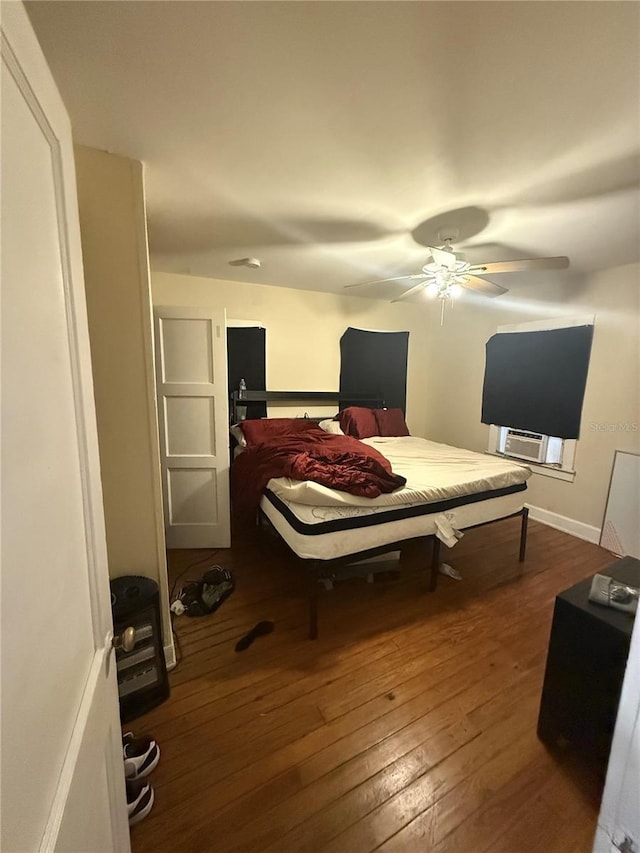 bedroom with dark wood finished floors, baseboards, and ceiling fan