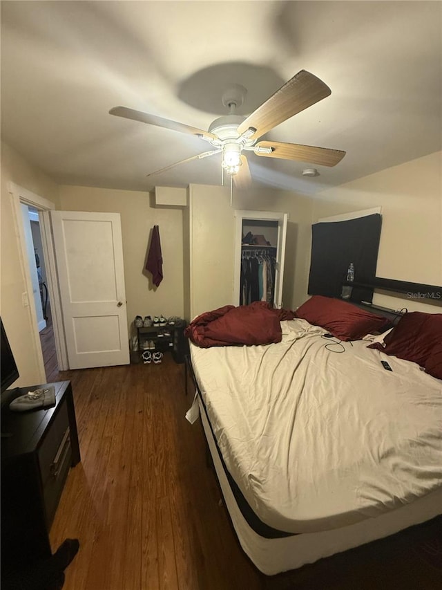 bedroom featuring dark wood-type flooring, a closet, and ceiling fan