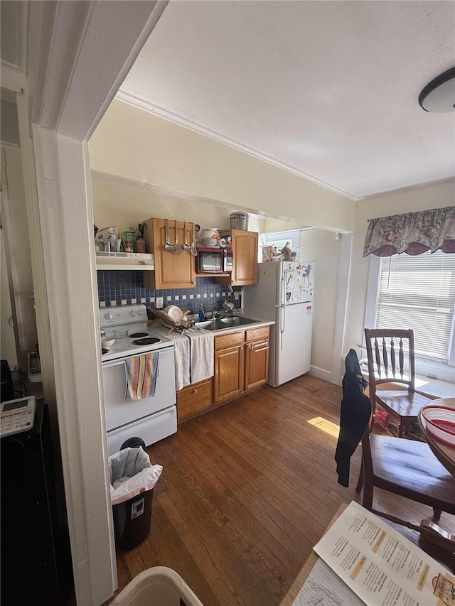 kitchen with open shelves, a sink, backsplash, white appliances, and dark wood-style flooring