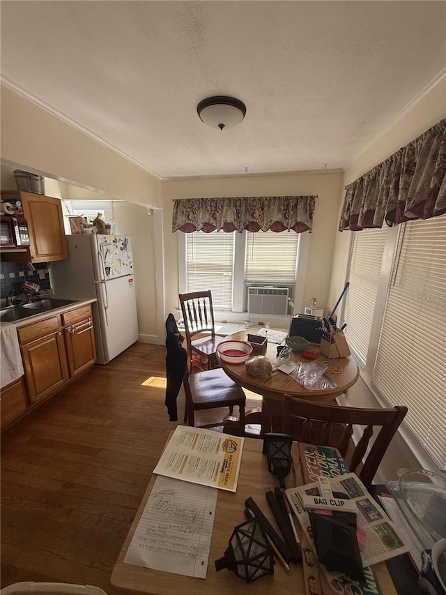 dining room featuring dark wood-style floors, cooling unit, and a textured ceiling