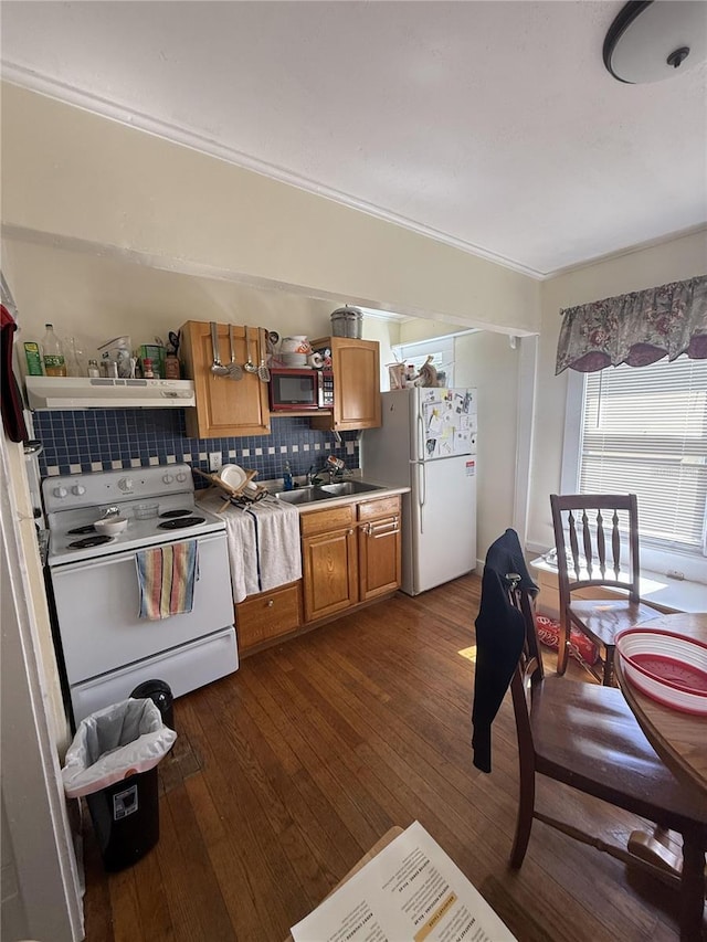 kitchen with dark wood-type flooring, open shelves, a sink, tasteful backsplash, and white appliances