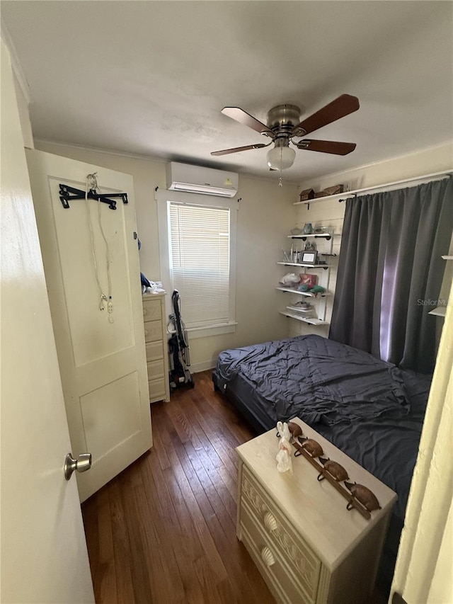 bedroom featuring dark wood-type flooring, an AC wall unit, and a ceiling fan