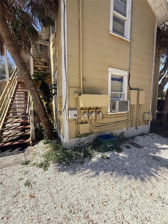 view of side of home featuring stairs