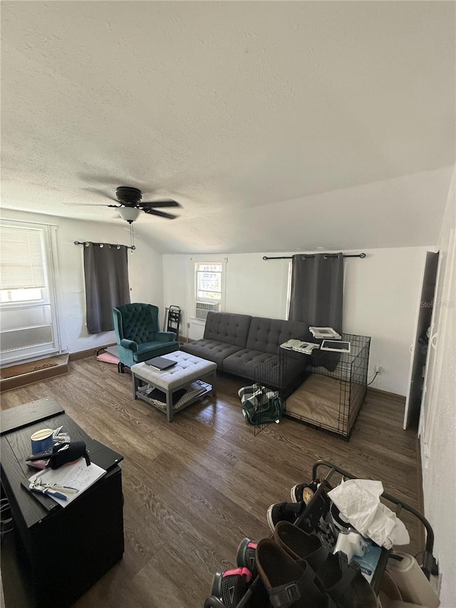 living room with ceiling fan, a textured ceiling, wood finished floors, and vaulted ceiling