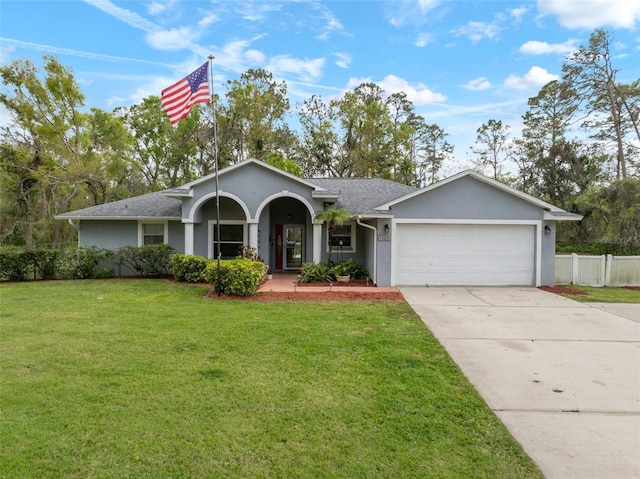 ranch-style home with stucco siding, driveway, an attached garage, a front yard, and fence