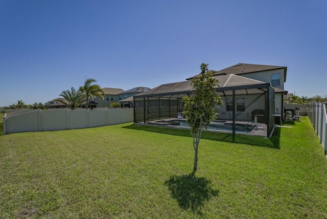 view of yard with glass enclosure, a fenced backyard, and a fenced in pool