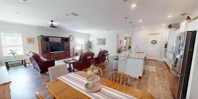 dining room featuring a wealth of natural light, visible vents, and crown molding