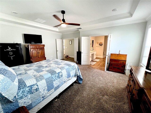 bedroom featuring visible vents, a raised ceiling, carpet, and ornamental molding