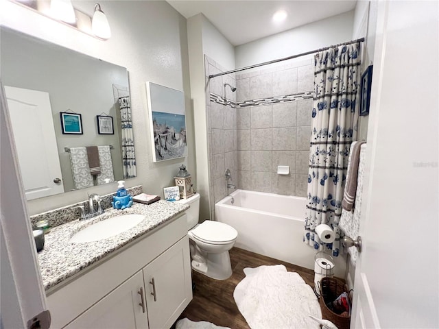 bathroom featuring shower / tub combo with curtain, wood finished floors, vanity, and toilet