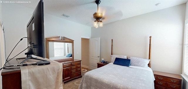 bedroom featuring visible vents, light carpet, and a ceiling fan