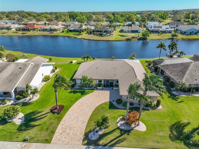 drone / aerial view with a residential view and a water view