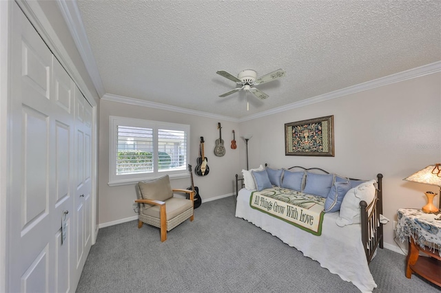 carpeted bedroom with a ceiling fan, baseboards, ornamental molding, a closet, and a textured ceiling