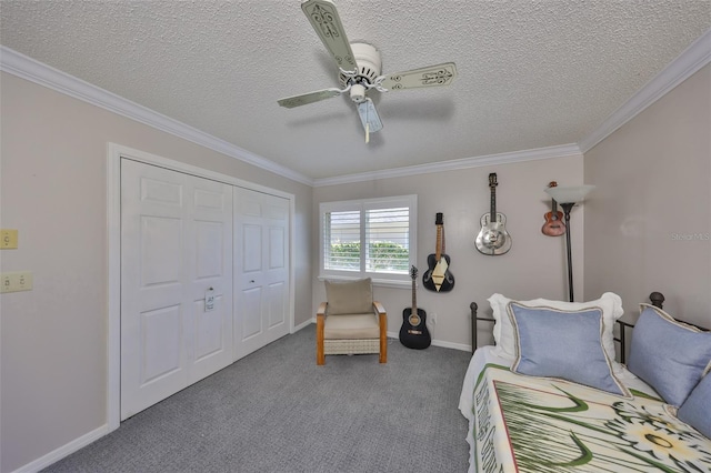 bedroom featuring a ceiling fan, baseboards, carpet floors, a closet, and crown molding