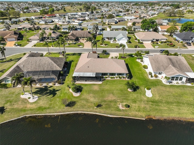 birds eye view of property with a residential view and a water view