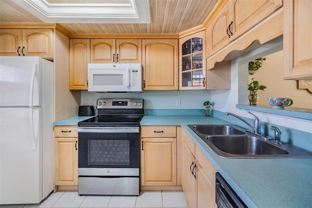 kitchen with a sink, glass insert cabinets, white appliances, and light brown cabinets