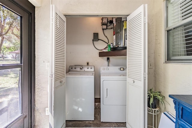 laundry area featuring laundry area, independent washer and dryer, and a textured wall