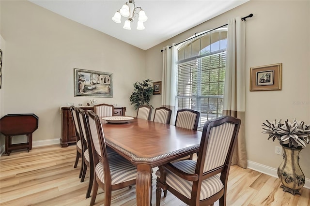 dining space featuring an inviting chandelier, light wood-style floors, and baseboards