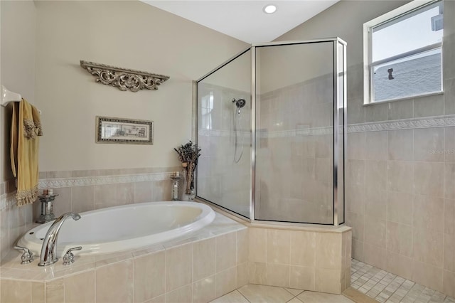 bathroom with a bath, tile patterned floors, and walk in shower