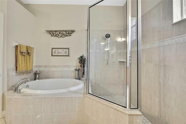 full bathroom featuring a garden tub and a stall shower