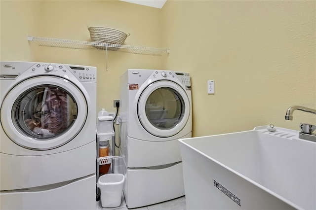 laundry area featuring washer and dryer, laundry area, and a sink