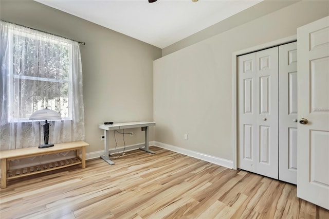 interior space featuring baseboards and wood finished floors