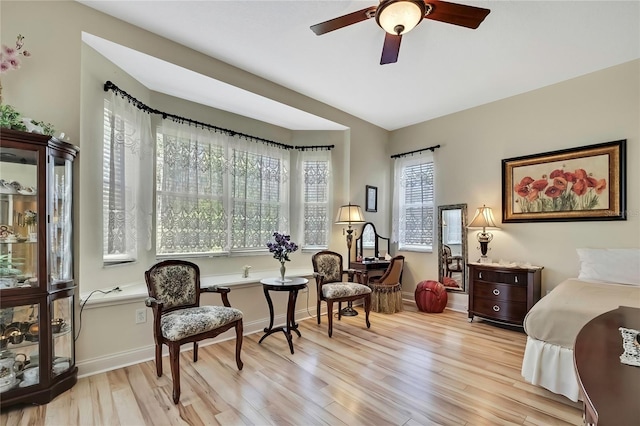 bedroom with baseboards, wood finished floors, and vaulted ceiling