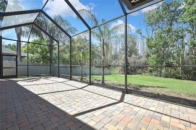 view of patio featuring glass enclosure