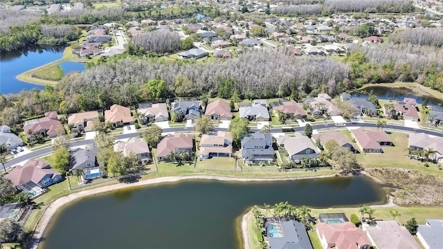 drone / aerial view with a residential view and a water view