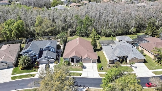 drone / aerial view with a residential view and a forest view