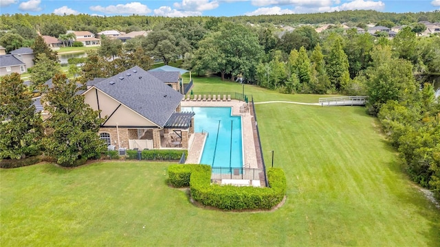 view of swimming pool with a yard and fence