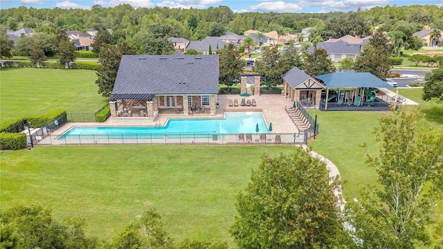 view of pool featuring a yard, a patio, a fenced in pool, and fence