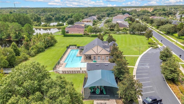 bird's eye view with a water view and a view of trees