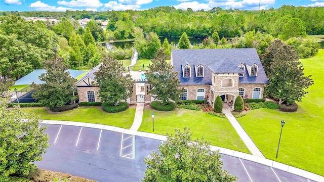 birds eye view of property featuring a view of trees