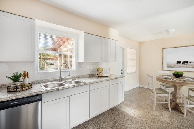 kitchen with tasteful backsplash, dishwasher, white cabinetry, and a sink